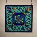 Stained glass panel with floral design on a plain background