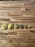Set of gold decorative plates on a wooden surface