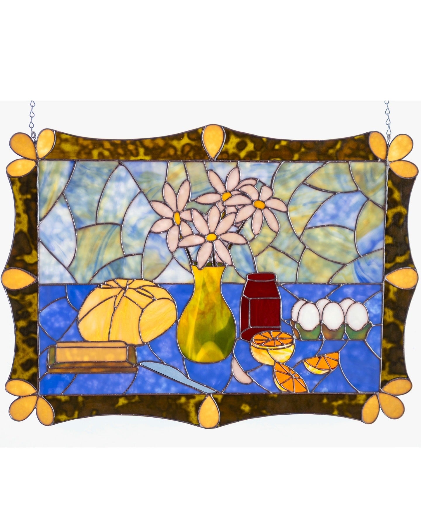 Stained glass panel with floral design and decorative elements on a white background