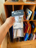 Hand holding a package of Bohle products in front of a shelf.