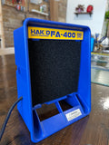 Blue Hakko FA-400 smoke absorber on a wooden surface.