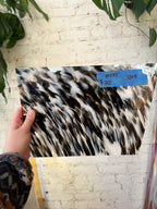 Glass sheet with a hand holding it, on a light-colored floor.