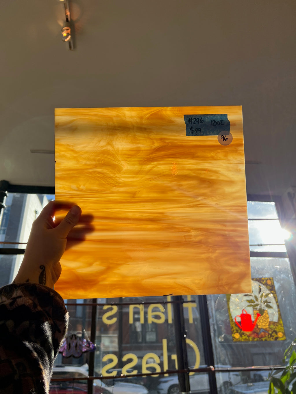 Person holding a glass sheet with a blurred background
