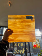 Person holding a glass sheet with a blurred background