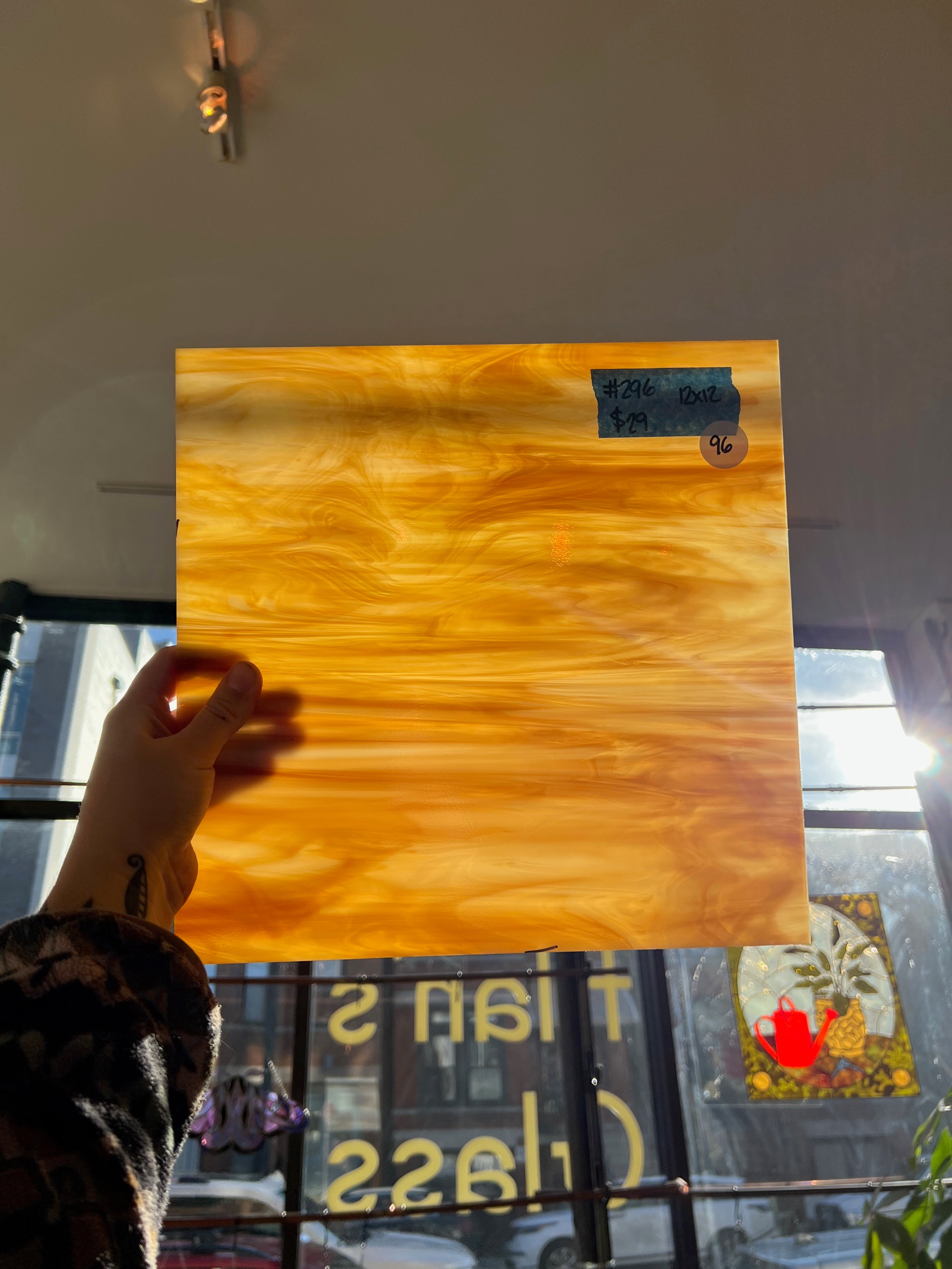 Person holding a glass sheet with a blurred background