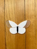 White glass butterfly on a wooden surface